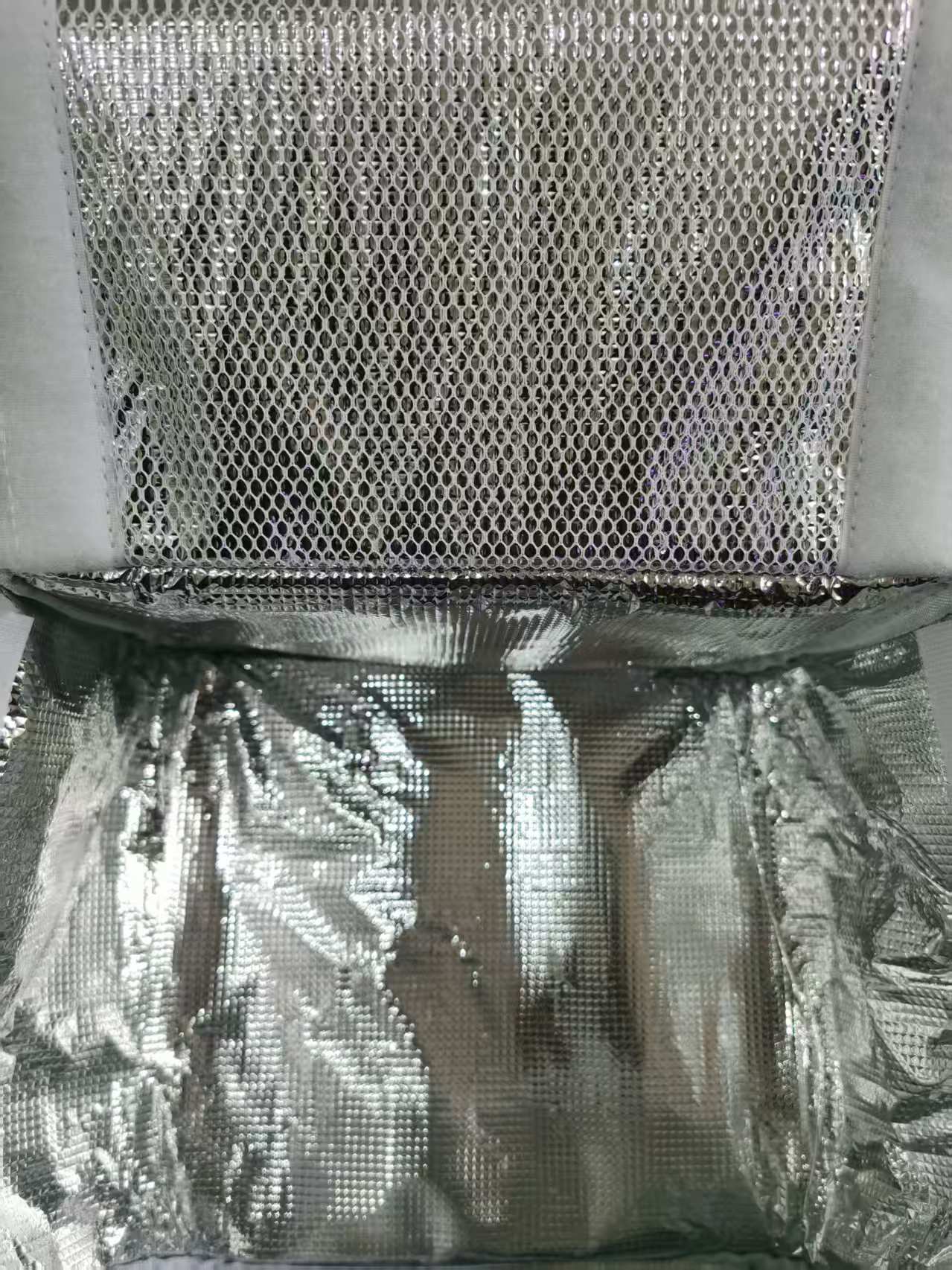 Close-up of aluminum foil lining inside an insulated cooler bag