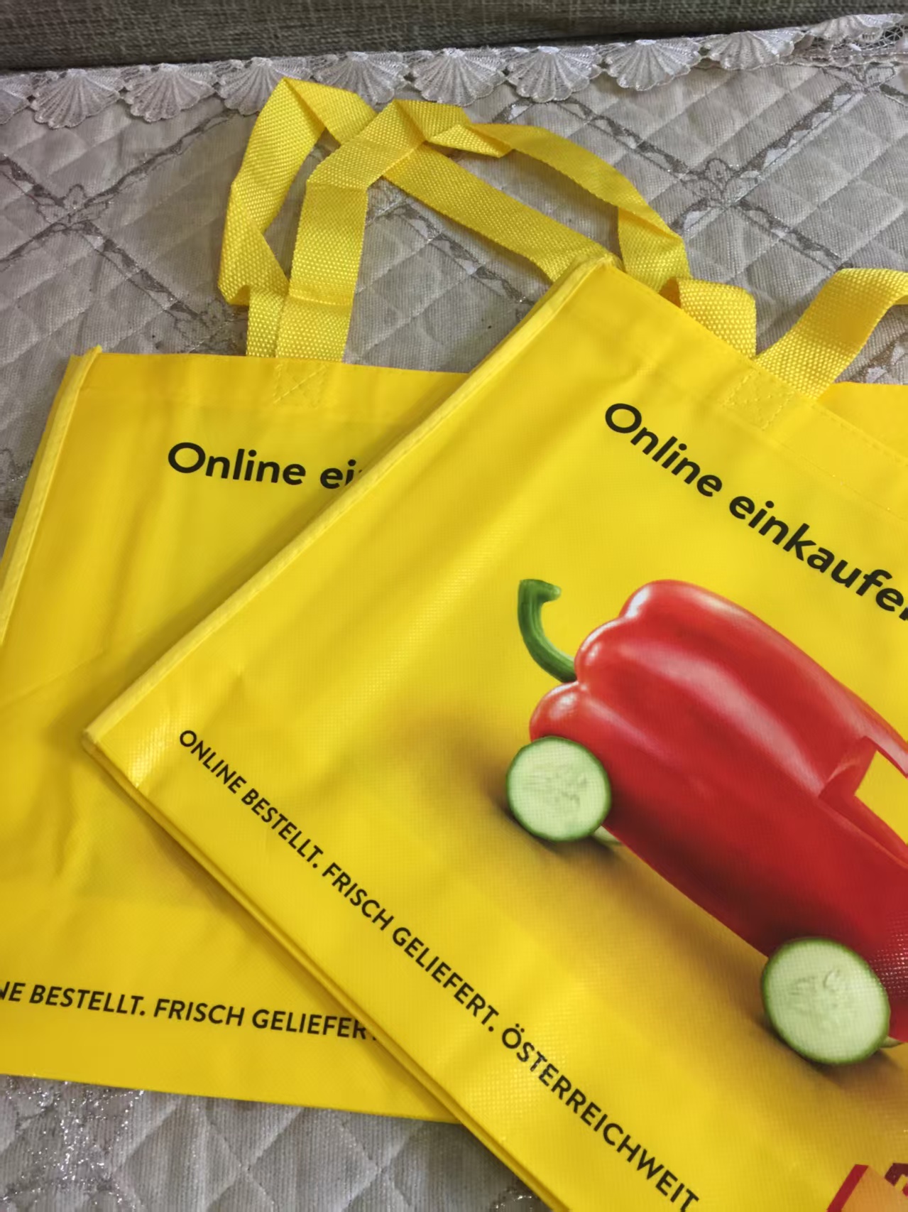 Two yellow custom non-woven grocery bags stacked