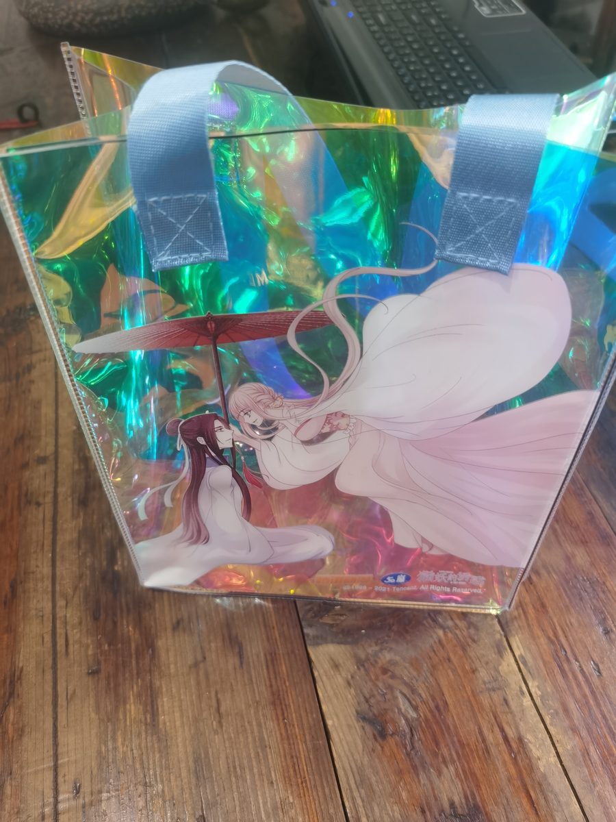 Iridescent PVC tote bag with anime character print and white handles